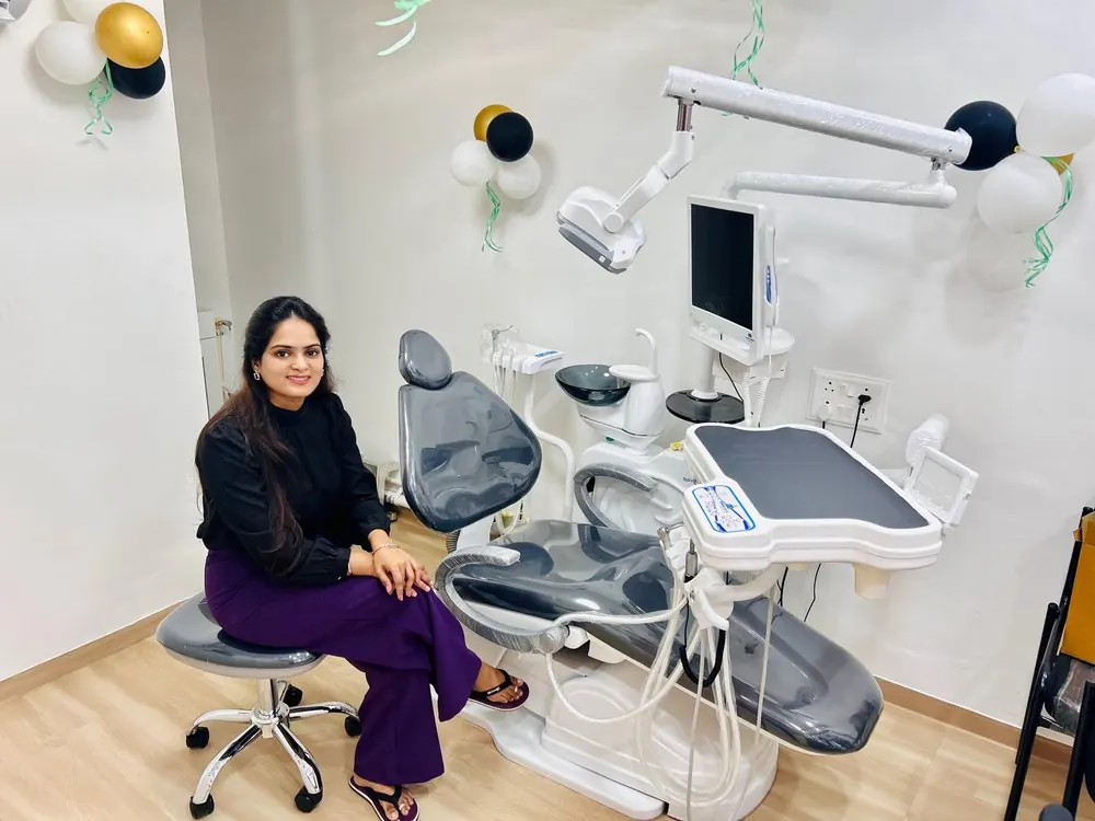 Dr. Pooja Biradar-Motagi seated beside a dental chair in a treatment room at Ekdant Dental Clinic
