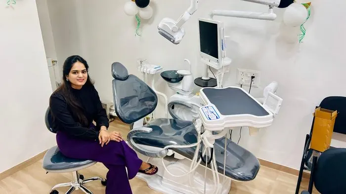 Dr. Pooja Biradar-Motagi seated beside a dental chair in a treatment room at Ekdant Dental Clinic